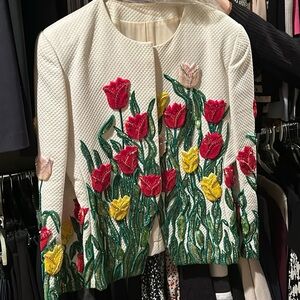 Custom Carolina Herrera jacket with a matching red skirt